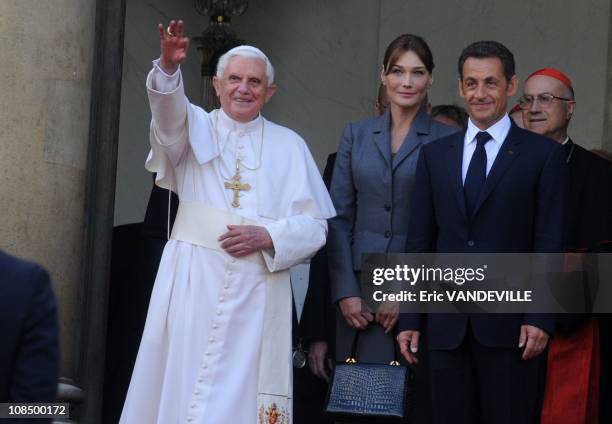 French President Nicolas Sarkozy and French first lady Carla Bruni Sarkozy welcome Pope Benedict XVI during an welcome ceremony at Orly airport on...