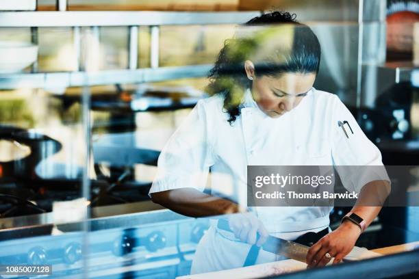 female chef preparing for dinner service in restaurant kitchen - dining experience stock pictures, royalty-free photos & images