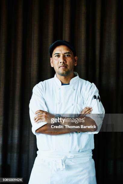 portrait of sous chef with arms crossed in standing in restaurant - chef portrait stock pictures, royalty-free photos & images