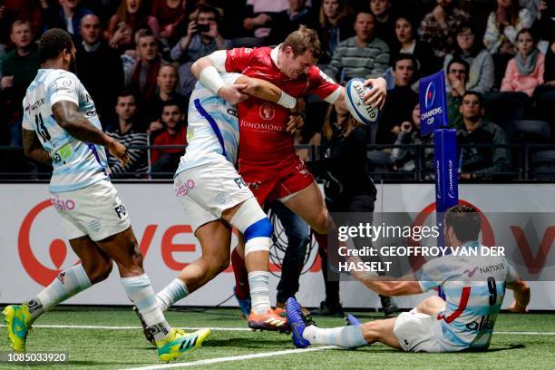 Scarlets' New Zealand centre Hadleigh Parkes fights for the ball with Racing 92's players during the European Rugby Champions Cup Pool 4 rugby union...