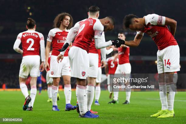 Alexandre Lacazette of Arsenal celebrates with teammate Pierre-Emerick Aubameyang after scoring his sides first goal during the Premier League match...