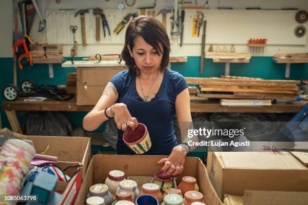 one woman with differing abilities at a ceramics studio - disabilitycollection ストックフォトと画像