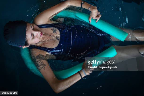 One woman taking swimming lessons