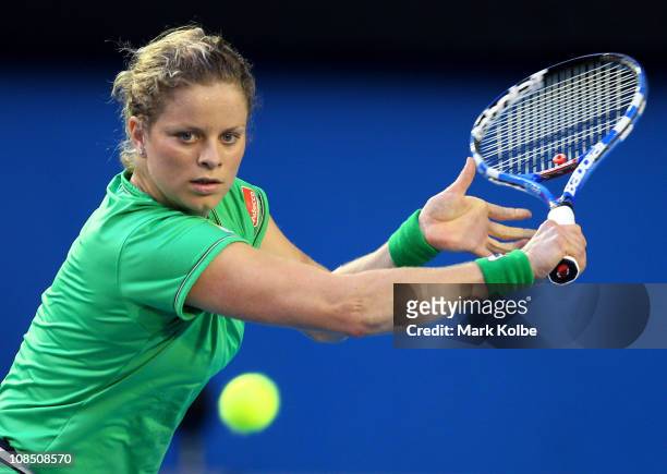 Kim Clijsters of Belgium plays a backhand in her women's final match against Na Li of China during day thirteen of the 2011 Australian Open at...