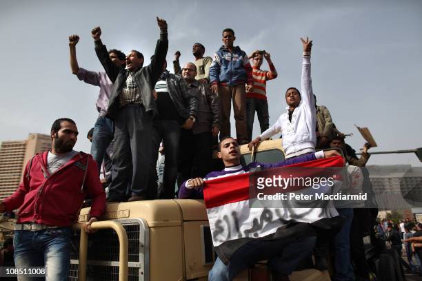 Protestors chant as they ride on an army tank transporter in Tahrir Square on January 29, 2011 in Cairo, Egypt. Tens of thousands of demonstrators...