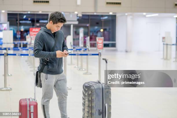 young asian japanese man travel by public transportation and waiting for plane in  airport japan - narita city stock pictures, royalty-free photos & images