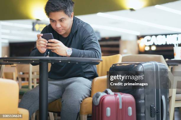 young asian japanese man travel by public transportation and waiting for plane in  airport japan - narita city stock pictures, royalty-free photos & images
