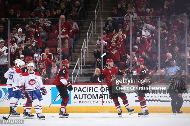 Oliver Ekman-Larsson of the Arizona Coyotes is congratulated by Christian Fischer and Alex Galchenyuk after scoring a power-play goal against the...