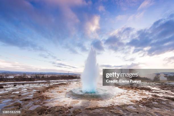 geyser erupting at sunrise - strokkur stock pictures, royalty-free photos & images