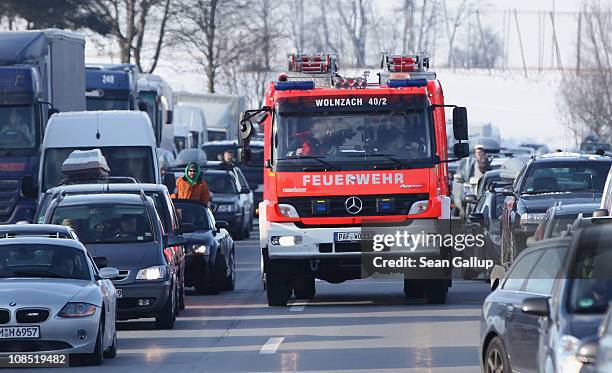 Firetruck makes its way past halted cars on its way to a severe accident that had stopped all traffic on the A9 highway on January 29, 2011 near...