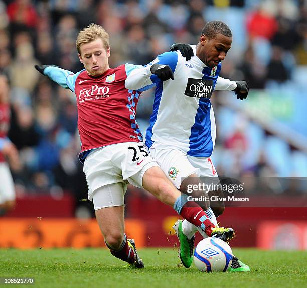 Barry Bannan of Aston Villa tackles Junior Hoilett of Blackburn Rovers during the FA Cup sponsored by E.On Fourth Round match between Aston Villa and...