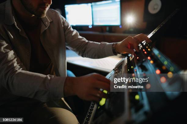 music producer working in recording studio - music producer stock pictures, royalty-free photos & images