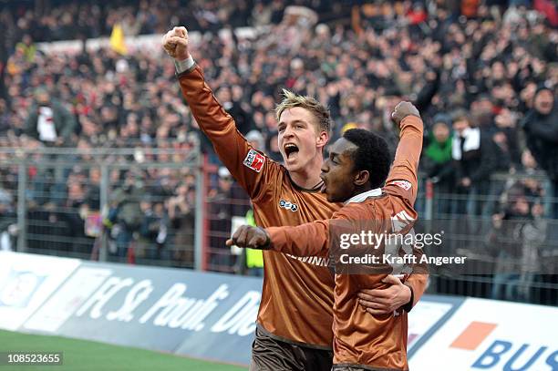 Charles Takyi and Bastian Oczipka of St. Pauli celebrate the second goal during the Bundesliga match between FC St. Pauli and 1. FC Koeln at...