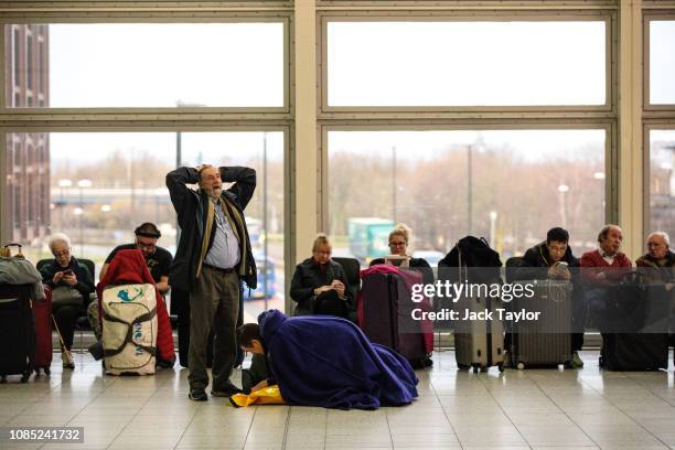 Passengers wait in the South Terminal building at London Gatwick Airport after flights resumed today on December 21, 2018 in London, England....