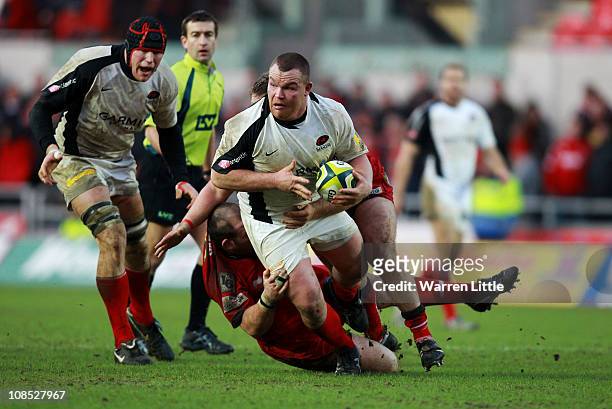 Matt Stevens of Saracens is tackled by Scarlets Captain, Phil John during the LV Anglo Welsh Cup between Scarlets and Saracens at Parc y Scarlets on...
