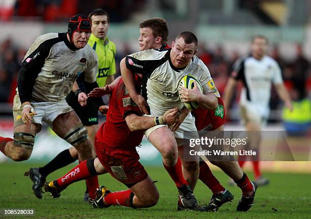 Matt Stevens of Saracens is tackled by Scarlets Captain, Phil John during the LV Anglo Welsh Cup between Scarlets and Saracens at Parc y Scarlets on...