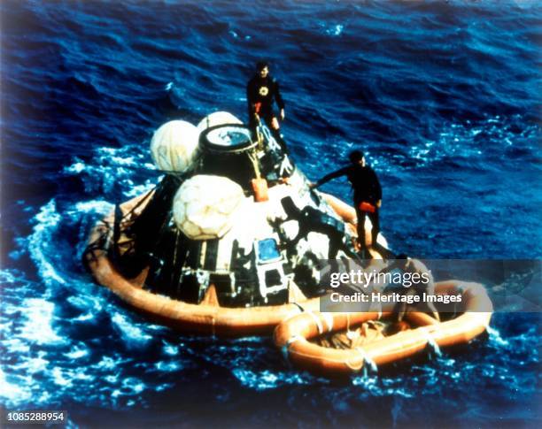 Recovery of command module 'Columbia' in the Pacific Ocean, Apollo II mission, 24 July 1969. US Navy divers assist in retrieving the astronauts from...