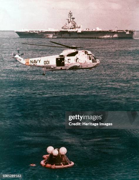 Astronauts being recovered from the sea, Apollo 16 mission, 27 April 1972. Prime recovery helicopter hovering over the Apollo 16 spacecraft after...