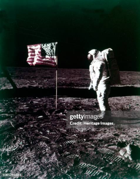 Buzz Aldrin stands next to the American flag on the surface of the Moon, Apollo 11 mission, July 1969. US astronaut Edwin E "Buzz" Aldrin, Jr, lunar...