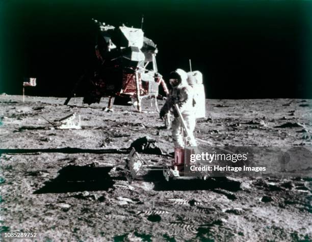 Buzz Aldrin sets up the seismic experiment, Apollo II mission, July 1969. Astronaut Buzz Aldrin on the lunar surface. The Apollo 11 Lunar Module,...