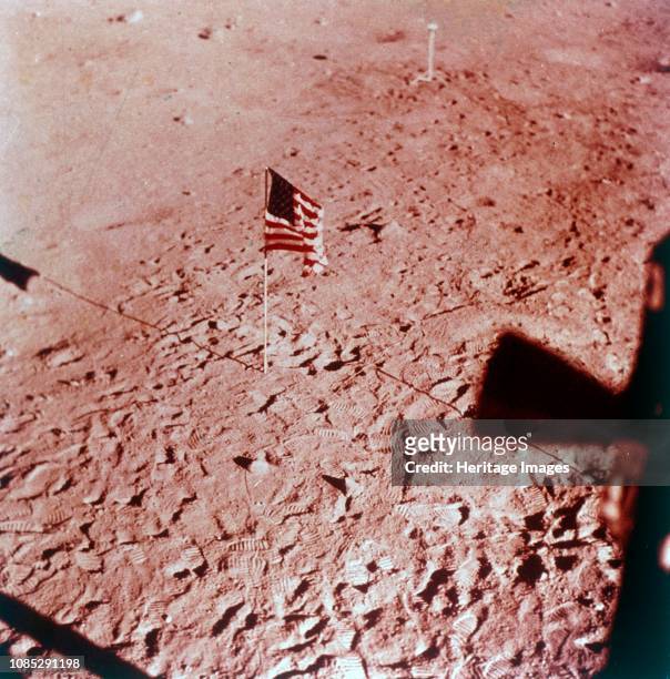 Flag on the Moon, Apollo 11 mission, July 1969. The American flag planted on lunar soil, seen from inside the Apollo 11 Lunar Module. The footprints...