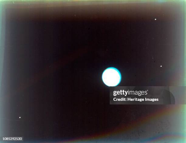 Uranus with satellites Miranda, Ariel and Umbriel, from Voyager 2, 24 January 1986. Composite of images taken by the unmanned Voyager 2 spacecraft...