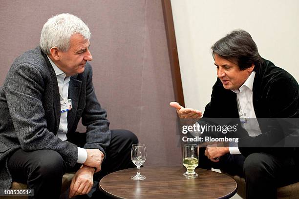 Alessandro Profumo, former chief executive officer of Unicredit SpA, left, speaks with Russian billionaire Rustam Tariko on the sidelines during the...