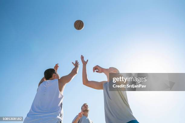 ball is connecting us - basketball blocking shot stock pictures, royalty-free photos & images