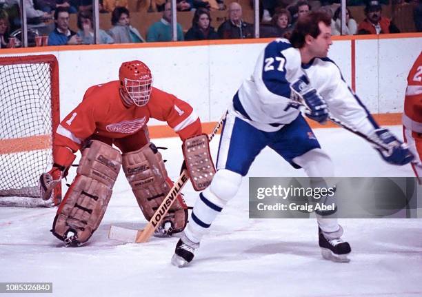 Dave Semenko of the Toronto Maple Leafs skates against Glen Hanlon of the Detroit Red Wings on January 30, 1988 at Maple Leaf Gardens in Toronto,...