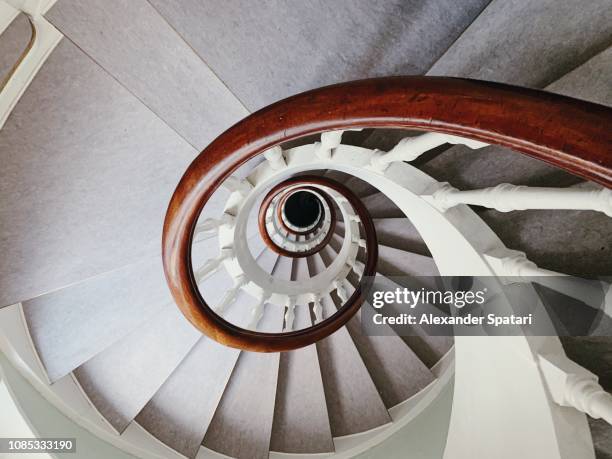 directly above view of a spiral staircase - hypnotherapy stock-fotos und bilder