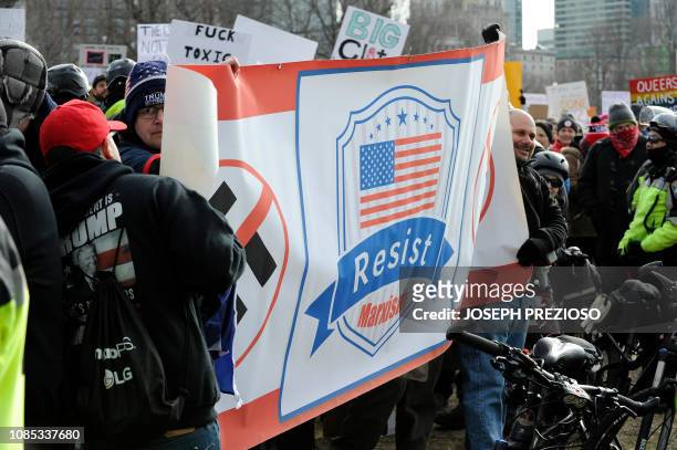 Right wing party members unveil a banner calling for people to resist Marxism during the 2019 Women's March at Boston Common in Boston,...