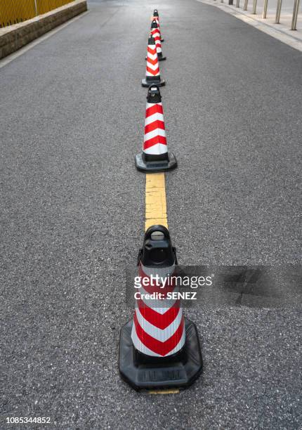 traffic cone,an image of cautions on asphalt road - traffic cone stock-fotos und bilder