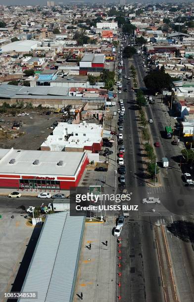 Aerial view of motorists waiting in line to buy gasoline at a Pemex service station in Guadalajara, Jalisco state on January 19, 2019. - Mexican...