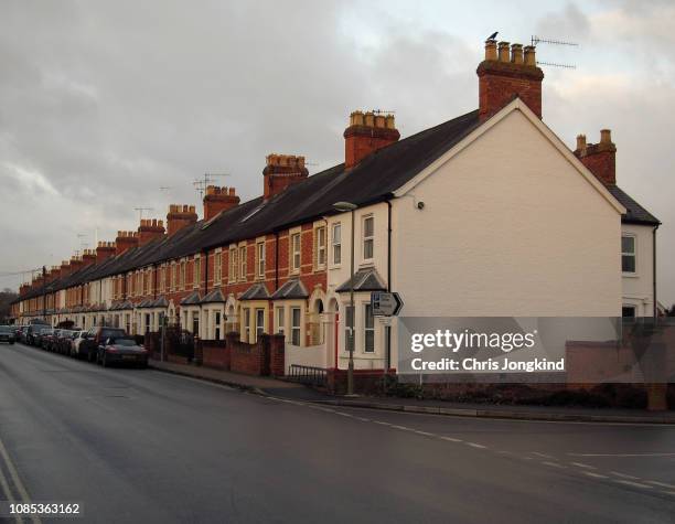 row of houses and cars on a quiet residential street - uk street stock pictures, royalty-free photos & images