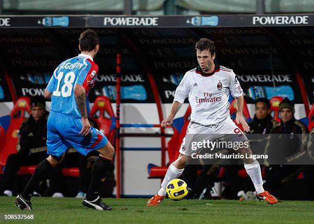 Antonio Cassano of Milan is challenged by Blazej Augustyn of Catania during the Serie A match between Catania Calcio and AC Milan at Stadio Angelo...