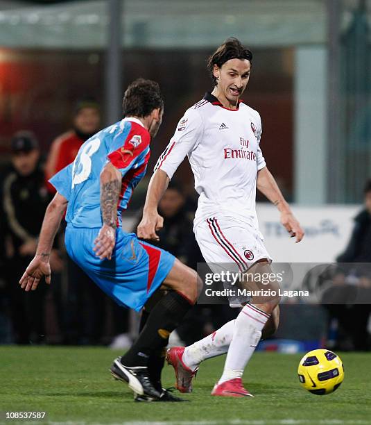 Blazej Augustyn of Catania and Zlatan Ibrahimovic of Milan battles for the ball during the Serie A match between Catania Calcio and AC Milan at...