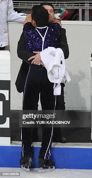 France's Florent Amodio celebrates with his Russian coach Nikolai Morozov after finishing his men's free programme of the European Figure Skating...