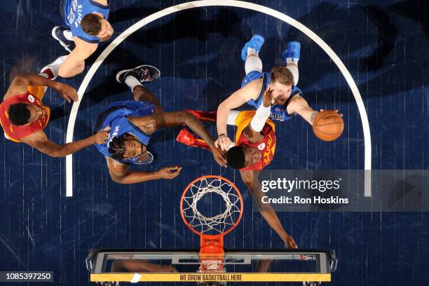 Victor Oladipo of the Indiana Pacers and Luka Doncic of the Dallas Mavericks go for a rebound during the game on January 19, 2019 at Bankers Life...