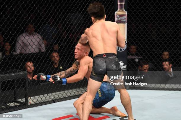 Henry Cejudo punches TJ Dillashaw in their flyweight bout during the UFC Fight Night event at the Barclays Center on January 19, 2019 in the Brooklyn...