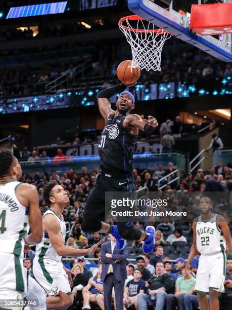 Terrence Ross of the Orlando Magic goes up for a dunk over Giannis Antetokounmpo and Malcom Brogdon of the Milwaukee Bucks during the game at the...