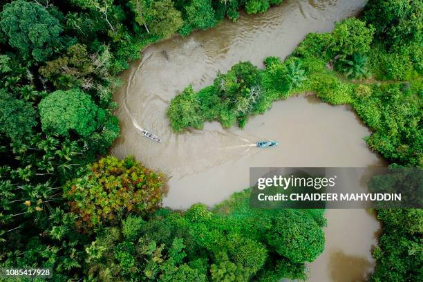 This aerial picture taken from a drone on January 12, 2019 shows Indonesian forest rangers on boats patrolling the Leuser ecosystem near Suaq...