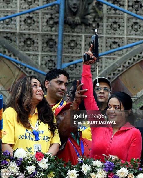 Indian Bollywood actress Tina Munim and playback singer Amruta Fadnavis participate in the Tata Mumbai Marathon in Mumbai on January 20, 2019.