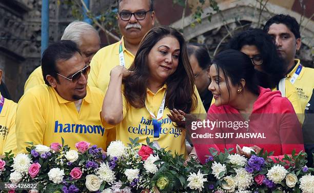 Indian Bollywood actors Gulshan Grover and Tina Munim along with playback singer Amruta Fadnavis attend the Tata Mumbai Marathon in Mumbai on January...