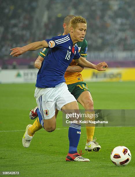 Keisuke Honda of Japan in action during the AFC Asian Cup Final match between the Australian Socceroos and Japan at Khalifa International Stadium on...