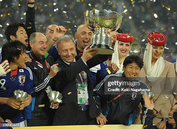 Japanese coach Alberto Zaccheroni and players celebrate after winning the AFC Asian Cup Final match between the Australian Socceroos and Japan at...