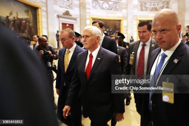 Acting White House Chief of Staff Mick Mulvaney and Vice President Mike Pence walk from the House of Representatives to the Senate while negotiating...