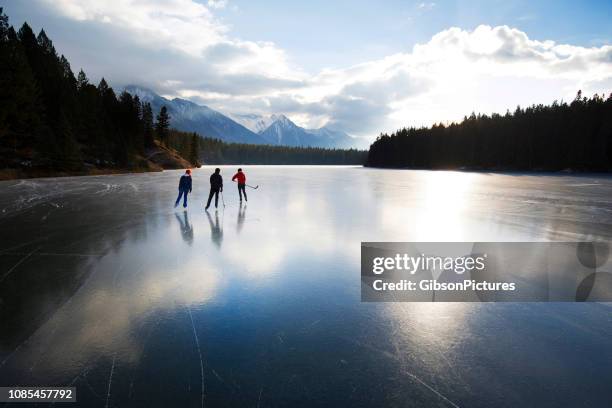 winter skating in banff national park - pond hockey stock pictures, royalty-free photos & images