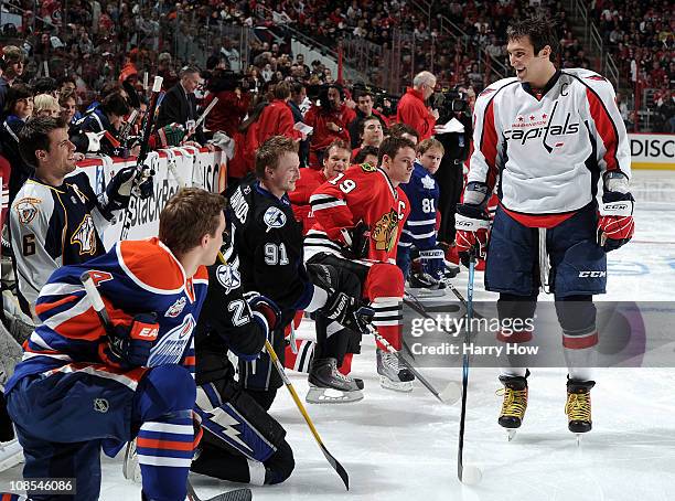 Alexander Ovechkin of the Washington Capitals skates by against Team Staal his competitors kneel after he won the breakaway challenge during the...