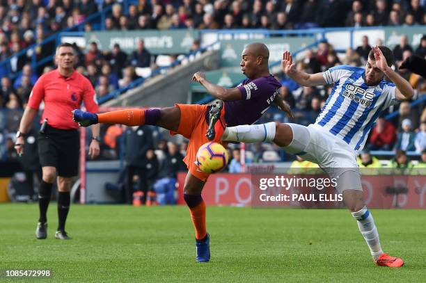 Manchester City's Brazilian midfielder Fernandinho shoots wide past Huddersfield Town's English defender Tommy Smith during the English Premier...