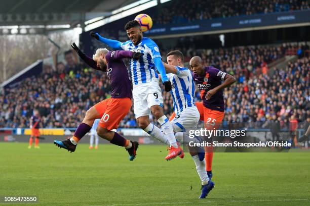 Sergio Aguero of Man City and Fernandinho of Man City battle for a header with Elias Kachunga of Huddersfield and Jonathan Hogg of Huddersfield...